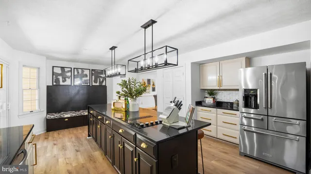 a kitchen with stainless steel appliances granite countertop a stove refrigerator and microwave