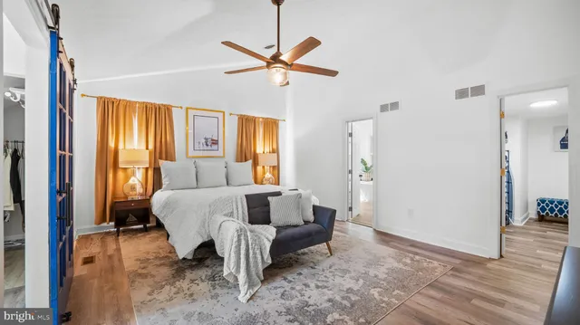 a bedroom with a bed and wooden floor