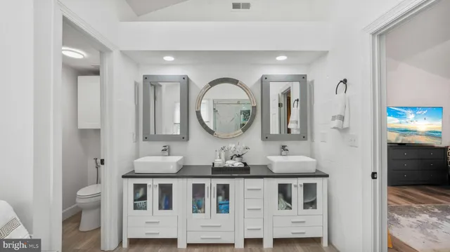a bathroom with a double vanity sink and a mirror