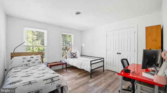 a bedroom with furniture and a wooden floor