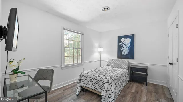 a bedroom with a bed and a chair