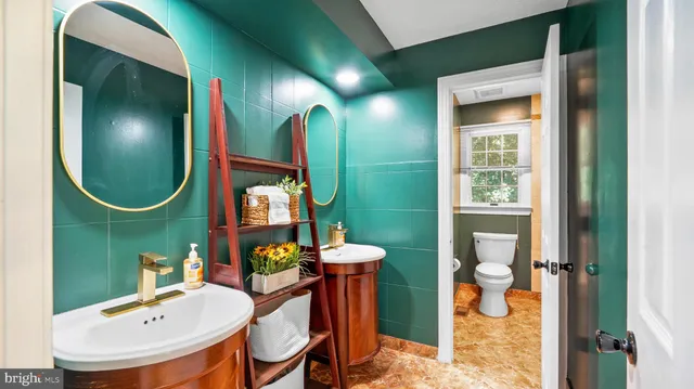 a bathroom with a sink mirror and toilet