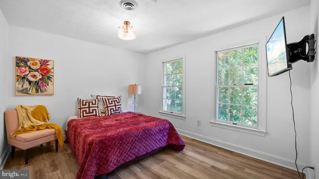 a spacious bedroom with a bed and a couch