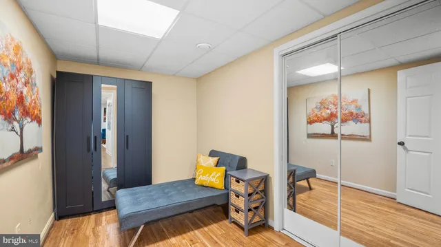 a view of a hallway with furniture and wooden floor
