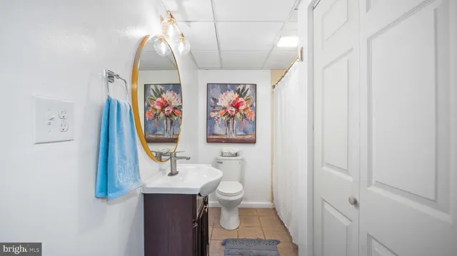 a bathroom with a sink a toilet and a mirror