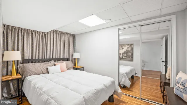 a bedroom with a bed and a mirror