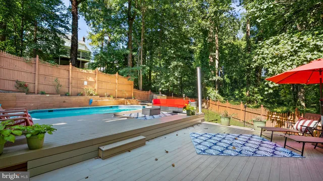swimming pool view with a seating space
