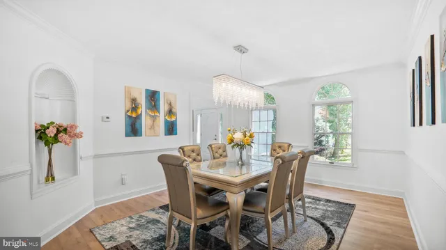 a dining room with furniture a window and a rug