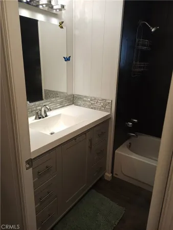 a bathroom with a sink a toilet and tub