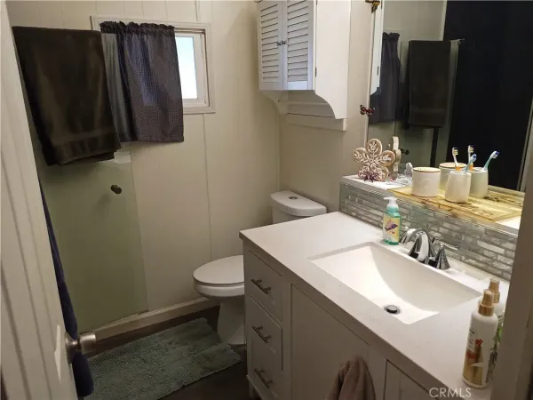 a bathroom with a sink a toilet and a mirror