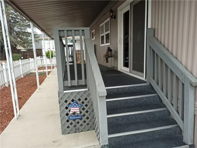 a view of a balcony with wooden floor and iron fence