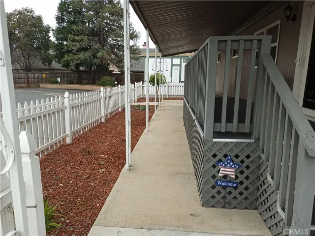 a view of a patio with table and chairs potted plants