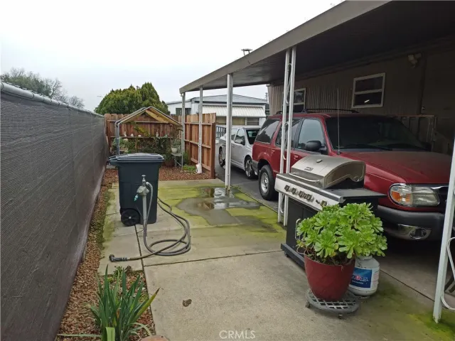 a view of a backyard with plants and patio