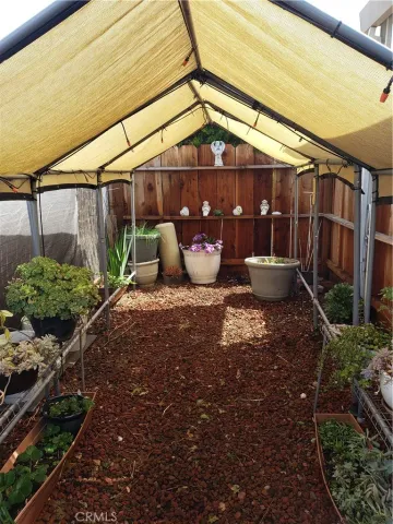 a view of a patio with table and chairs potted plants