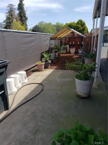 a view of a porch with furniture and plants