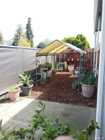 a view of a patio with chair and table and chairs under an umbrella