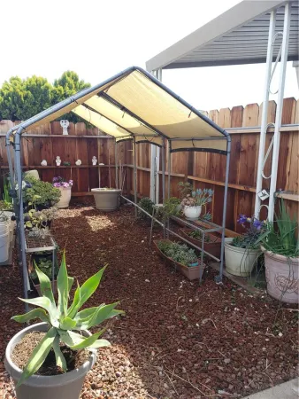 a backyard of a house with barbeque oven table and chairs