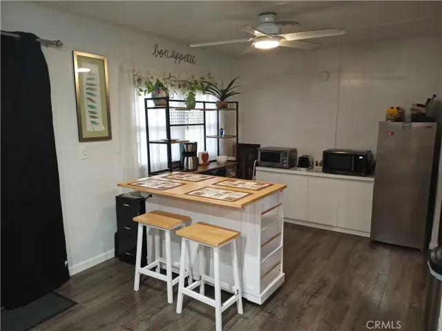 a kitchen with kitchen island a dining table and chairs