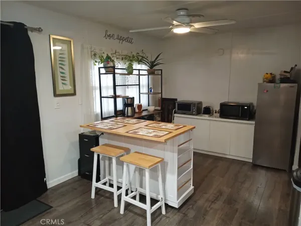 a kitchen with kitchen island a dining table and chairs