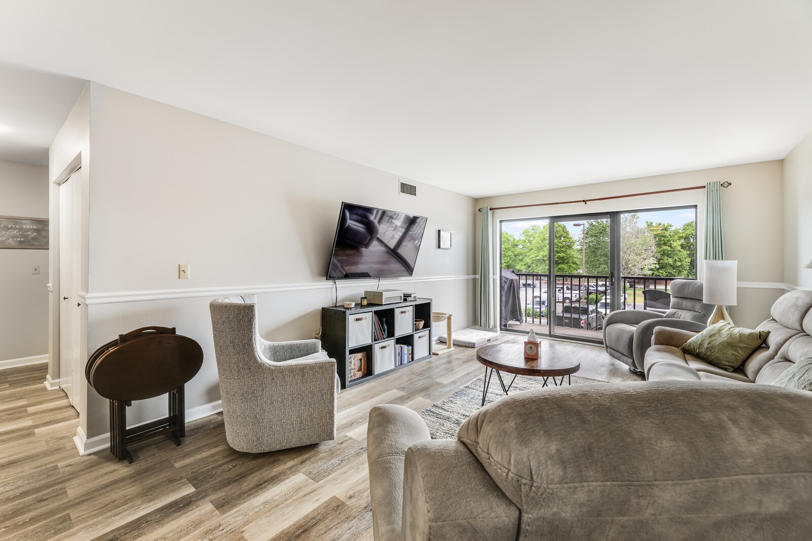 a living room with furniture and a floor to ceiling window