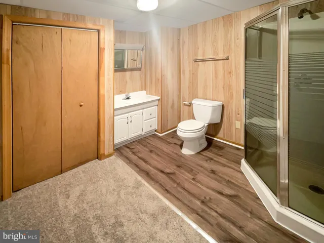 a bathroom with a toilet shower and a sink