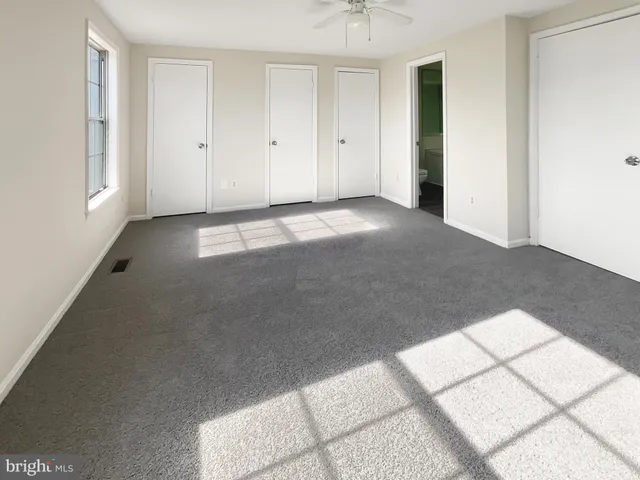 a view of an empty room with windows