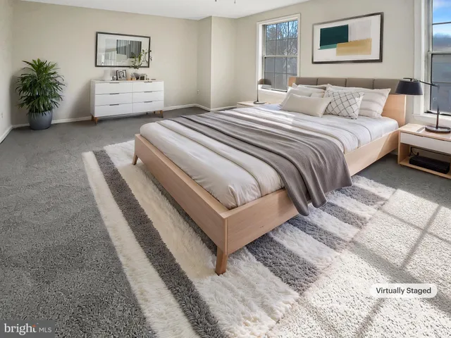 a bedroom with a bed and a couch