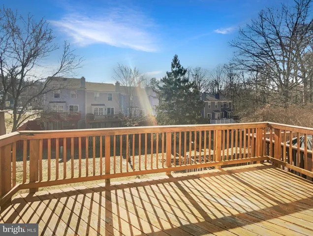 a view of balcony with wooden floor and fence
