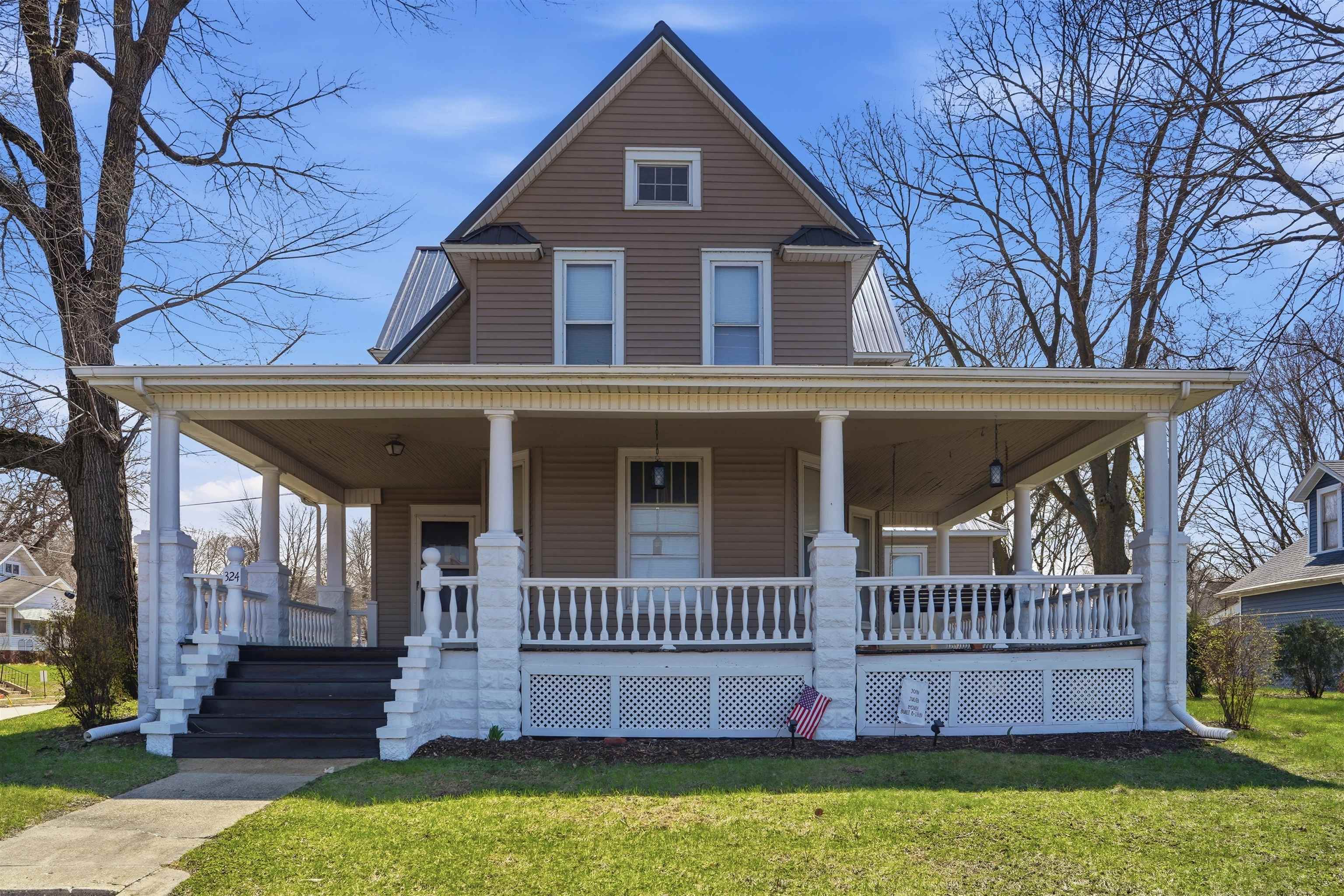 324 East 2nd Street Dixon, IL 61021 - Photo 1 of 25 a view of a brick house with a deck and a yard