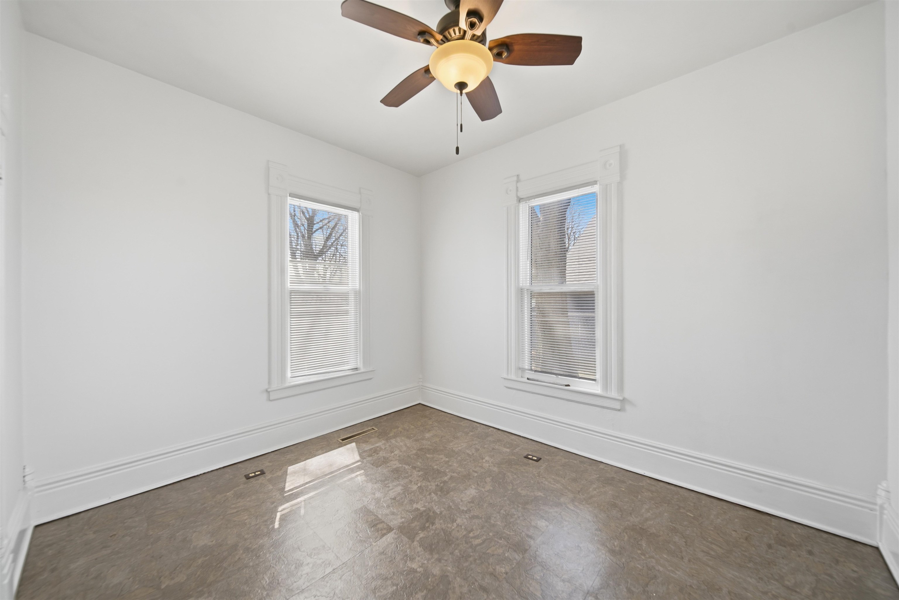324 East 2nd Street Dixon, IL 61021 - Photo 13 of 25 an empty room with chandelier fan and windows