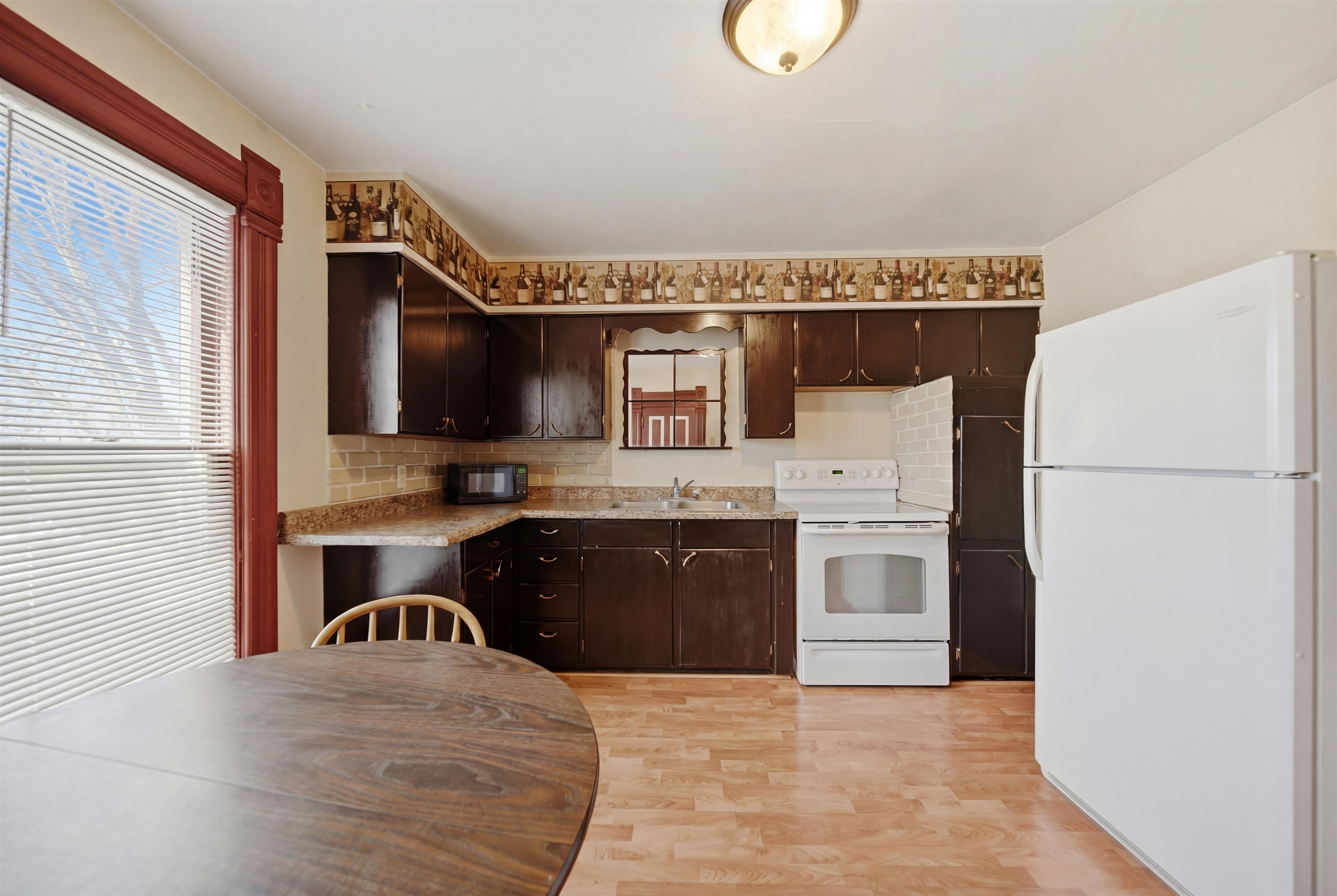 324 East 2nd Street Dixon, IL 61021 - Photo 15 of 25 a kitchen with a stove a sink and a refrigerator