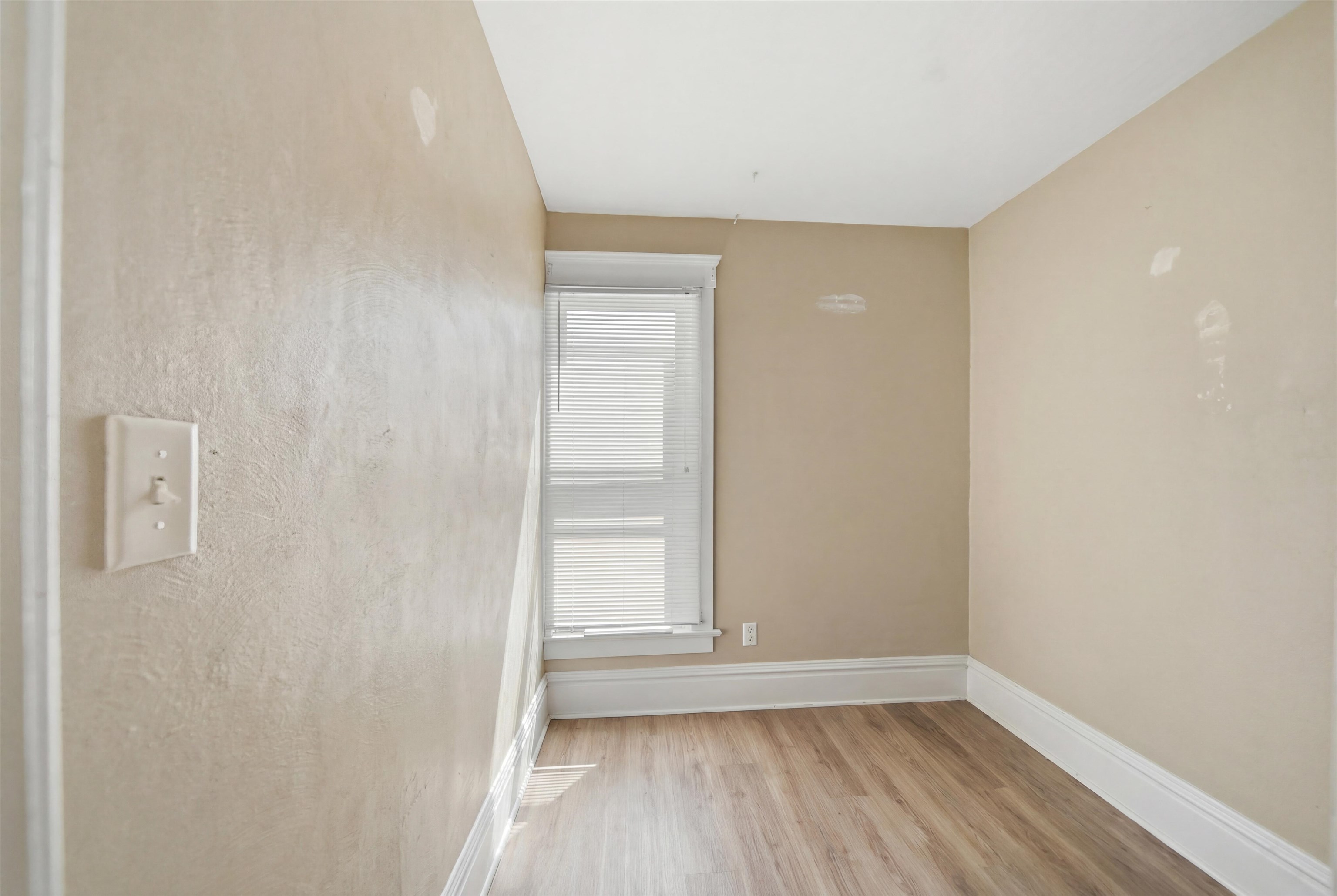 324 East 2nd Street Dixon, IL 61021 - Photo 19 of 25 a view of an empty room with wooden floor and a window