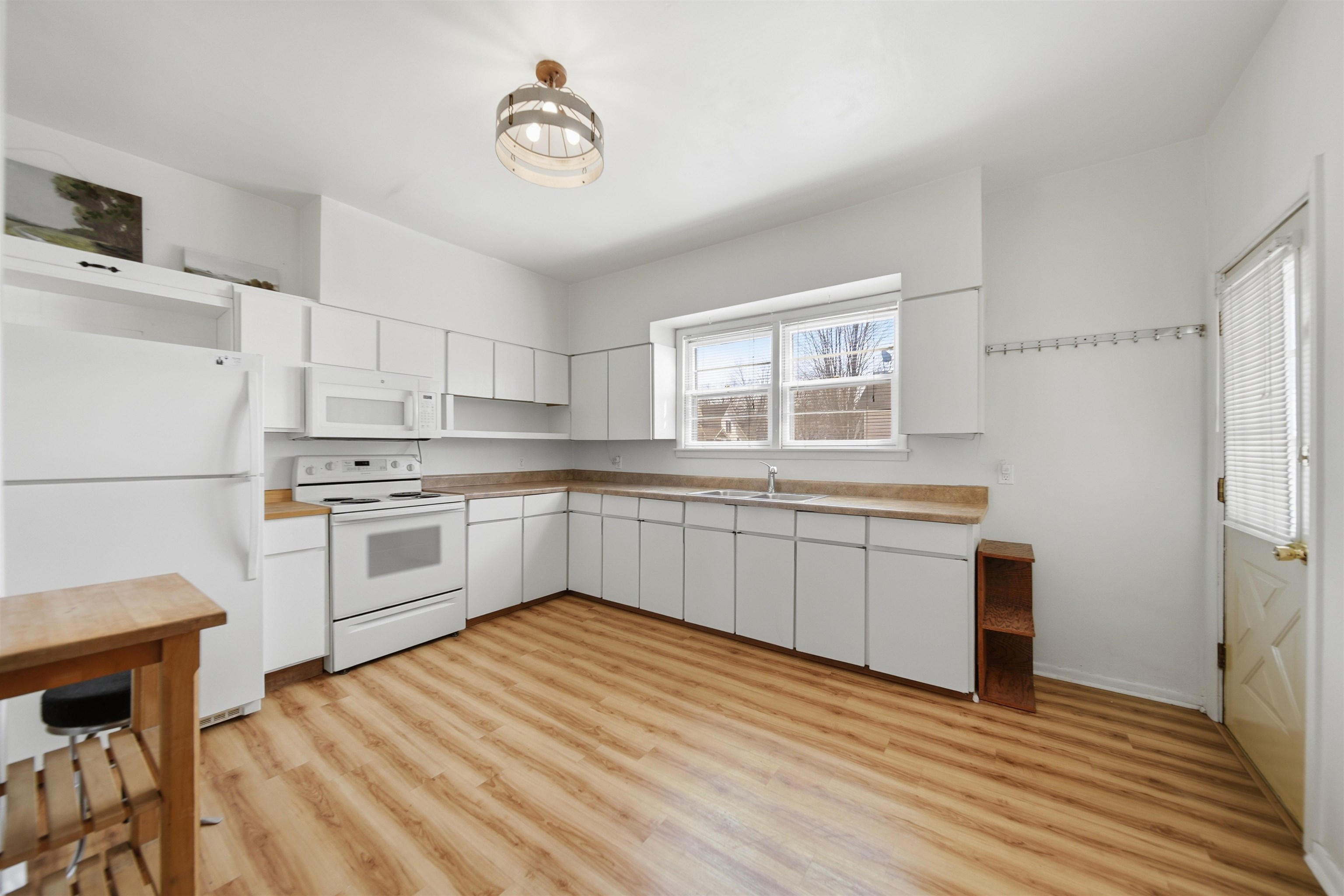 324 East 2nd Street Dixon, IL 61021 - Photo 9 of 25 a kitchen with white cabinets and white appliances