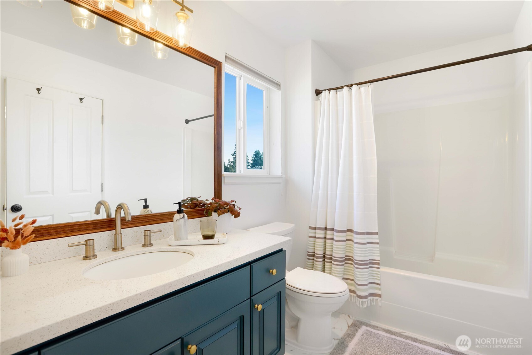 7531 148th Place Southeast Snohomish, WA 98296 - Photo 23 of 29 a bathroom with a double vanity sink toilet mirror and shower