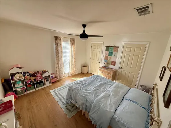 a bed room with a bed and a chandelier