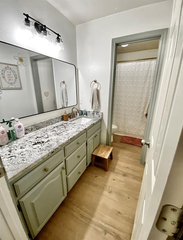 2 Broadmoor Court Bonham, TX 75418 - Photo 12 of 22 a bathroom with a granite countertop sink and a mirror
