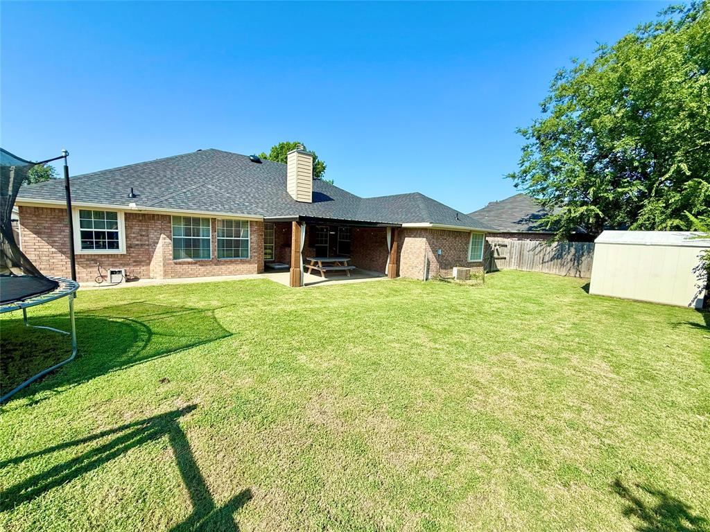 2 Broadmoor Court Bonham, TX 75418 - Photo 14 of 22 a front view of a house with a yard and green space