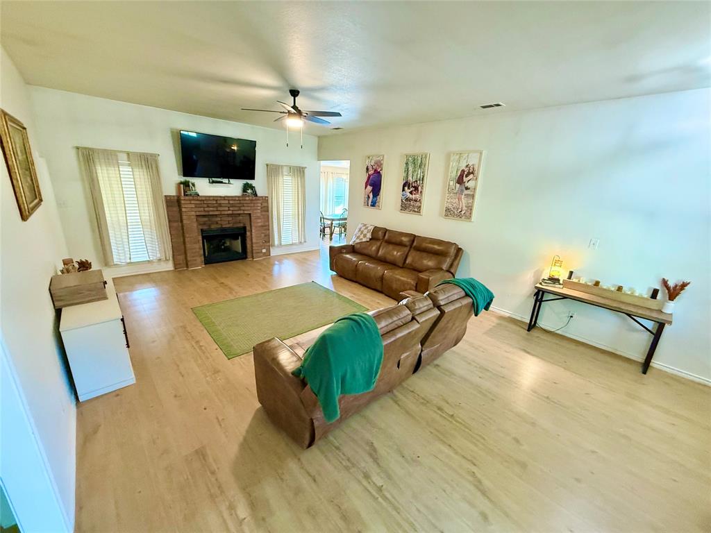 2 Broadmoor Court Bonham, TX 75418 - Photo 17 of 22 a living room with furniture and a fireplace