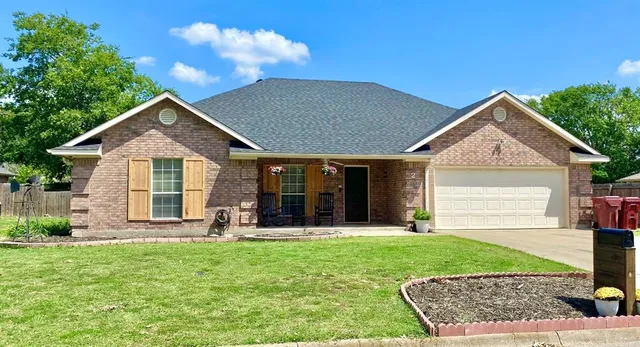 a front view of a house with a yard and garage