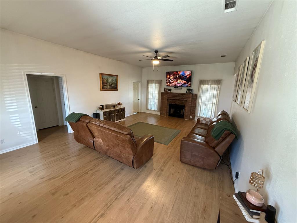 2 Broadmoor Court Bonham, TX 75418 - Photo 3 of 22 a living room with furniture a fireplace and a flat screen tv
