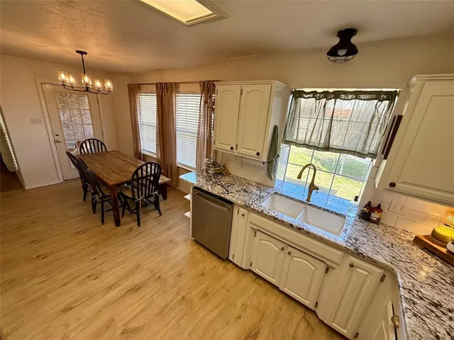 a living room with stainless steel appliances granite countertop furniture and a kitchen view