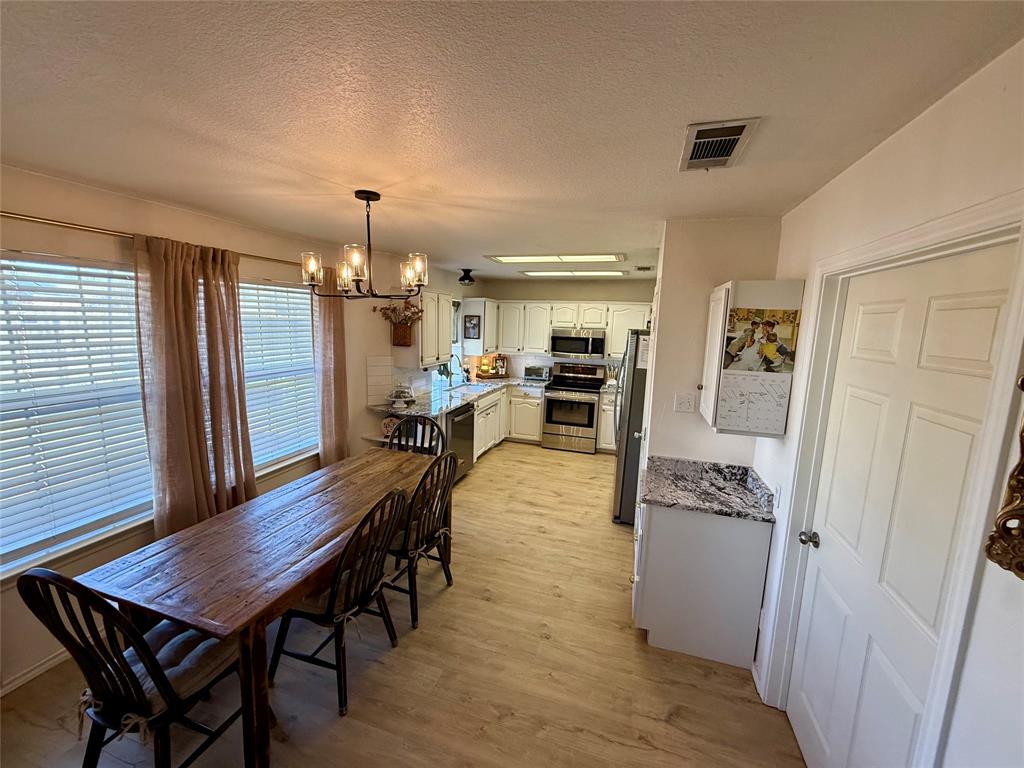 2 Broadmoor Court Bonham, TX 75418 - Photo 5 of 22 a dining room with furniture and wooden floor