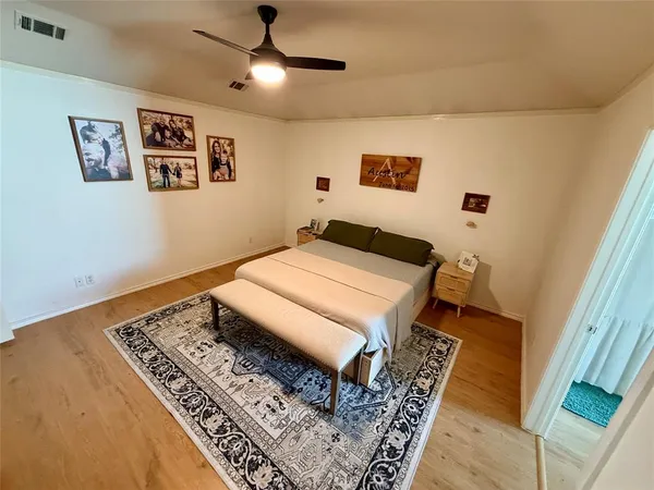a bedroom with a bed and a rug