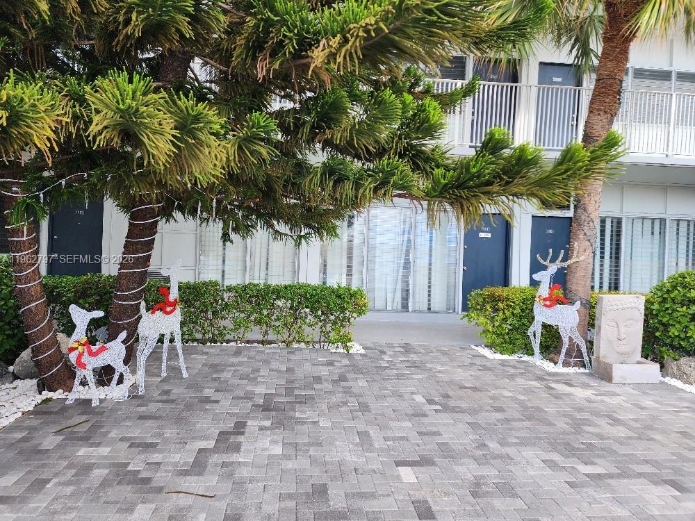 2101 Normandy Drive, Unit 204 Miami Beach, FL 33141 - Photo 4 of 43 a view of a backyard with a table and chairs