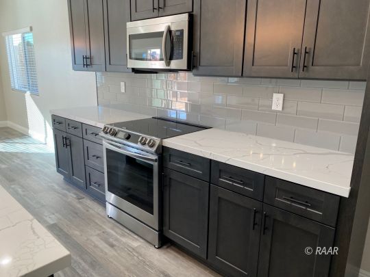 1034 Ocean Avenue Ridgecrest, CA 93555 - Photo 8 of 30 a kitchen with a sink stove and microwave