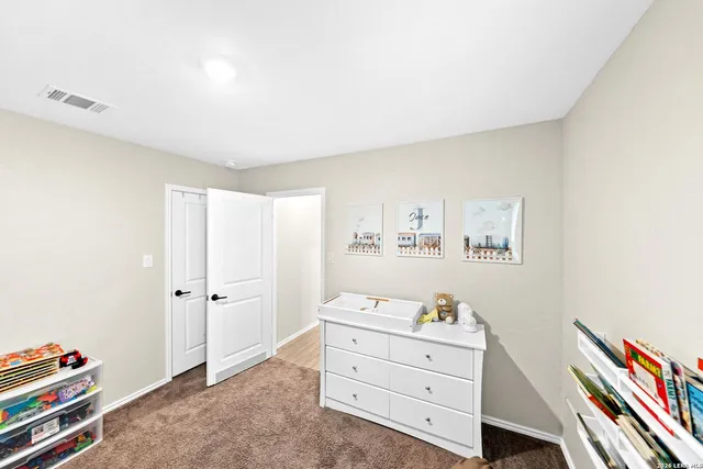 a bedroom with furniture and a wooden floor