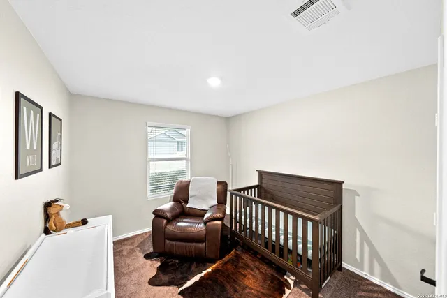 a bedroom with a bed and a television