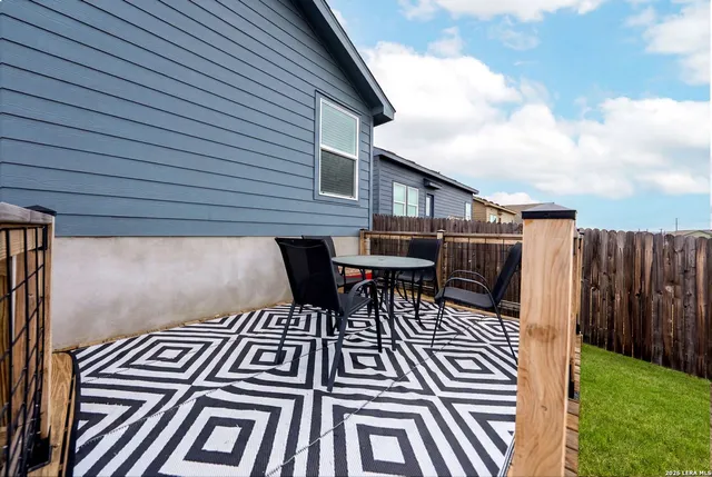 a view of a backyard with seating area and green space