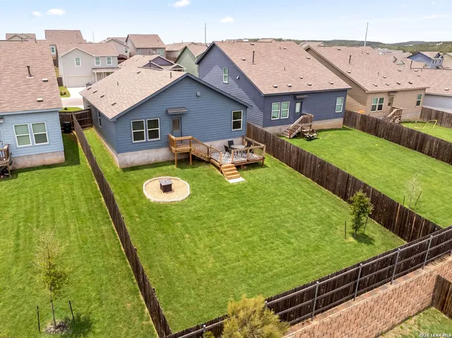 an aerial view of a house with garden space and deck