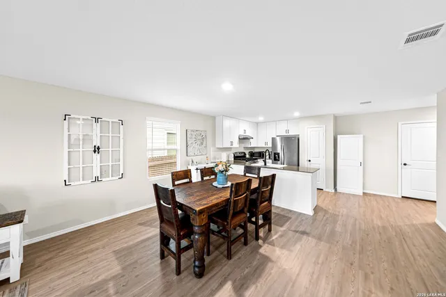 a view of a dining room with furniture and wooden floor